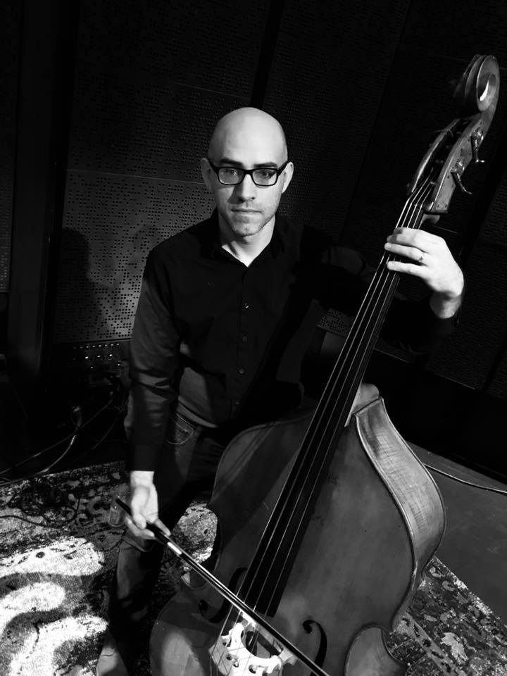 Andrew Bergmann performing on acoustic bass with a bow